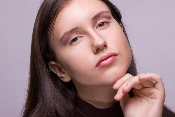 Studio emotional portrait of a beautiful young brunette woman with natural make-up — Stock Photo, Image