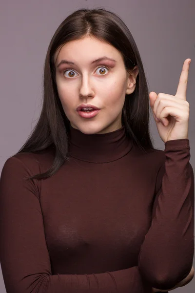 Studio emotional portrait of a beautiful young brunette woman with natural make-up — Stock Photo, Image