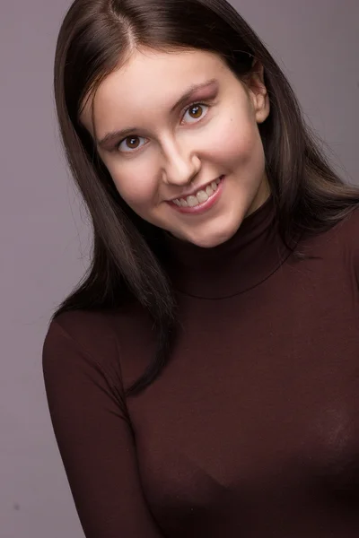 Studio emotional portrait of a beautiful young brunette woman with natural make-up — Stock Photo, Image