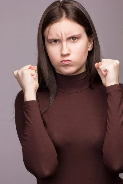 Studio emotional portrait of a beautiful young brunette woman with natural make-up — Stock Photo, Image