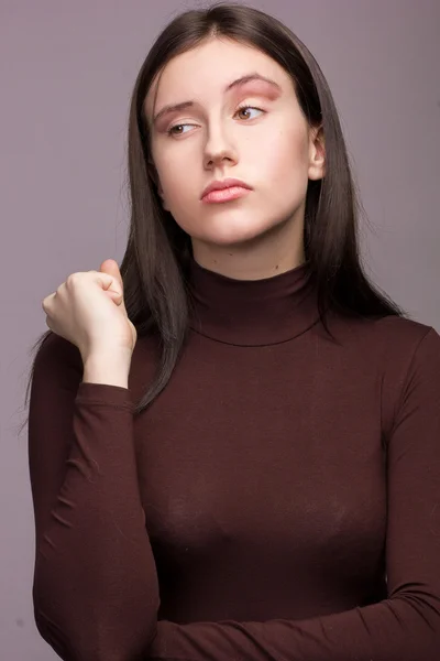 Studio emotional portrait of a beautiful young brunette woman with natural make-up — Stock Photo, Image