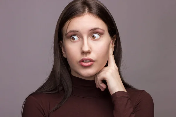 Studio emotional portrait of a beautiful young brunette woman with natural make-up — Stock Photo, Image