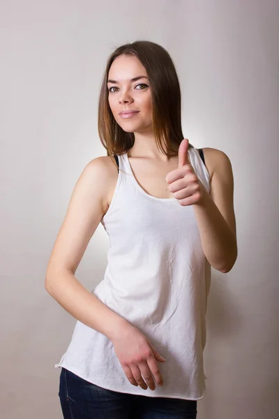 Portret van een mooie jonge vrouw in een wit t-shirt met natuurlijke make-up en rechtstreeks bruin haar — Stockfoto