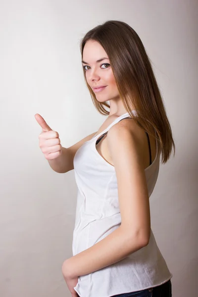 Portrait of a beautiful young woman in a white T-shirt with natural make-up and straight brown hair — Stock Photo, Image