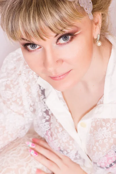 Portrait of a beautiful young blonde woman in sexy lace blouse. — Stock Photo, Image