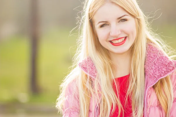 Portrait of blond woman in red maxi dress outdoor — Stock Photo, Image