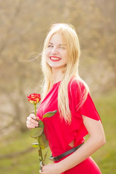 Porträtt av blond kvinna i röd maxi klänning utomhus — Stockfoto