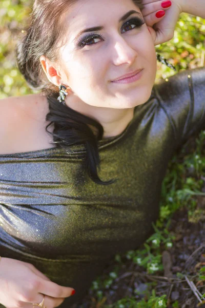 Luxury woman in a long black evening dress in the park — Stock Photo, Image