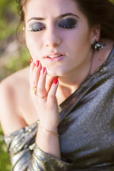 Luxury woman in a long black evening dress in the park — Stock Photo, Image