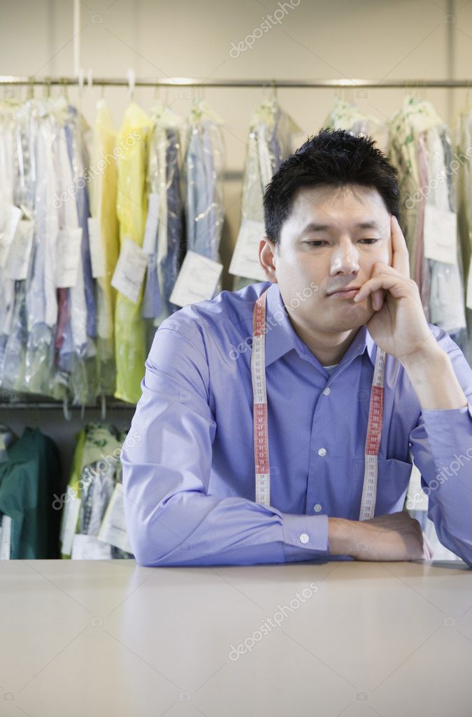 Bored Asian dry cleaner — Stock Photo © bst2012 13229563