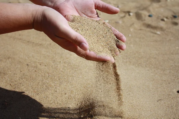 Sand flows down from palms Royalty Free Stock Photos