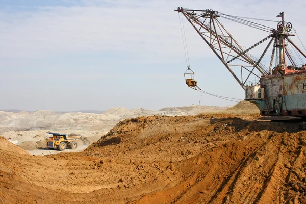 Powerful dredge and passing by lorry — Stock Photo, Image