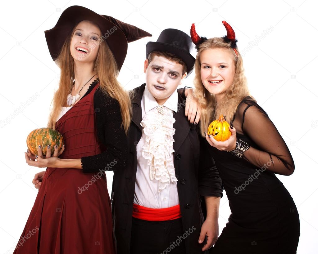 Teenagers dressed in costumes for Halloween against white backg
