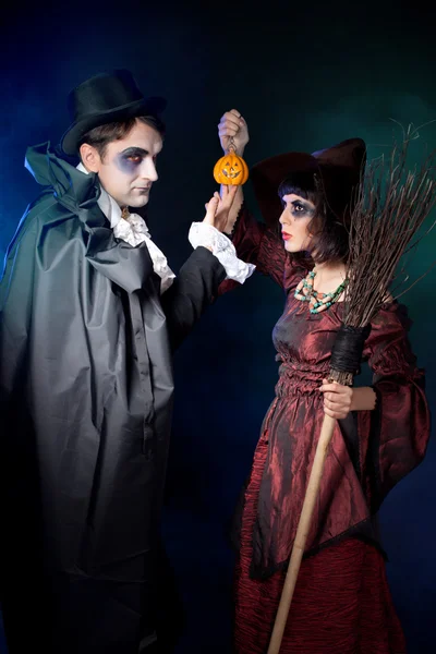 Man and woman wearing as vampire and witch. — Stock Photo, Image