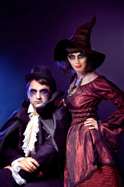 Man and woman wearing as vampire and witch. — Stock Photo, Image