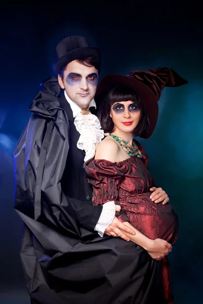 Man and woman wearing as vampire and pregnant witch. Hallowe — Stock Photo, Image
