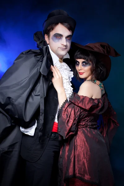 Man and woman wearing as vampire and witch. — Stock Photo, Image