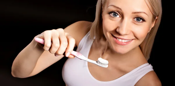 Positive pregnant blond woman checks her teeth — Stock Photo, Image