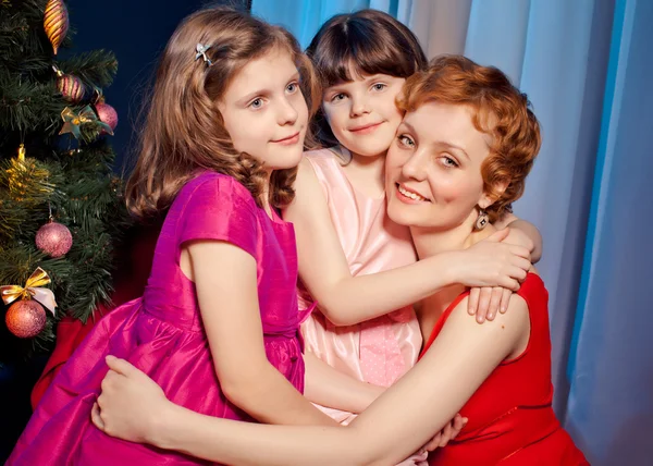 Mother and daughters near Christmas tree — Stock Photo, Image