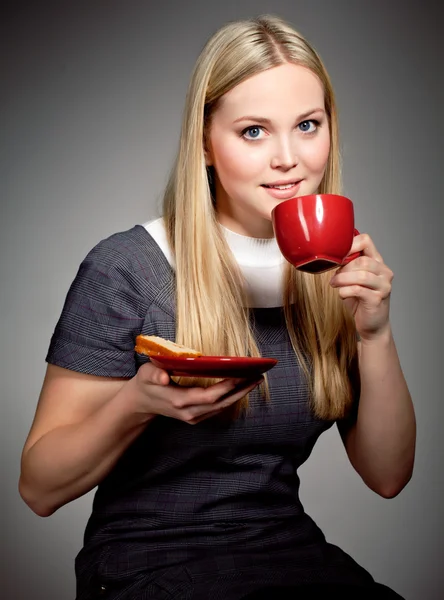 Красивая молодая женщина пьет кофе или чай — стоковое фото