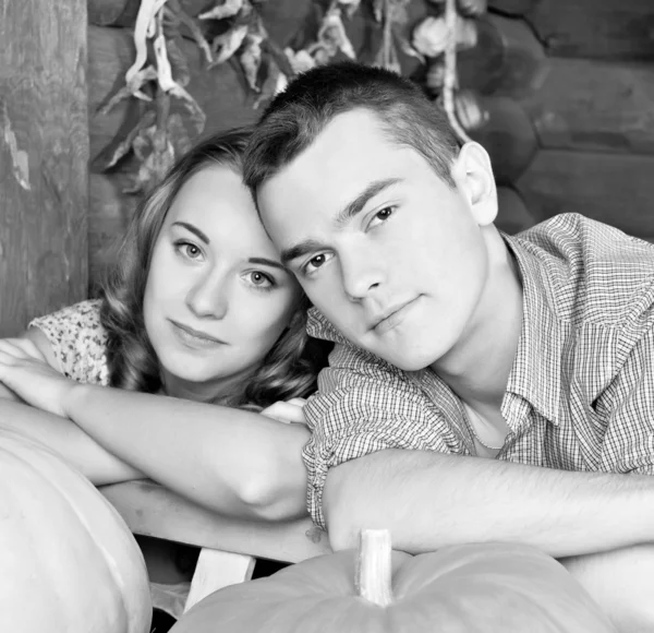 Young couple standing together, posing in studio, looking at ca — Stock Photo, Image
