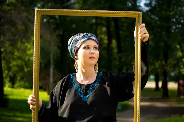 Girl wearing a turban and a stylized ethnic costum — Stock Photo, Image