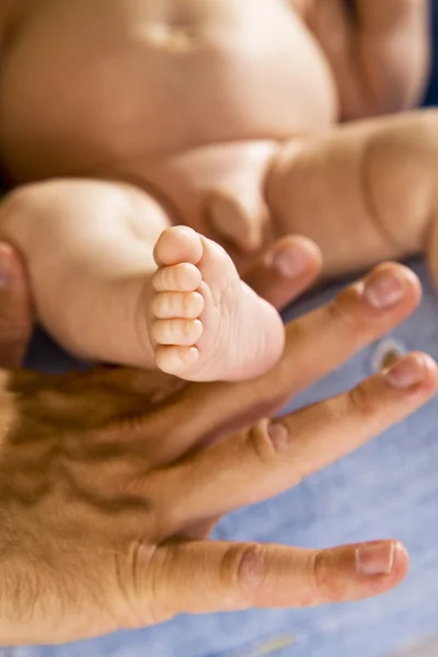 Babys foot held in hand — Stock Photo, Image