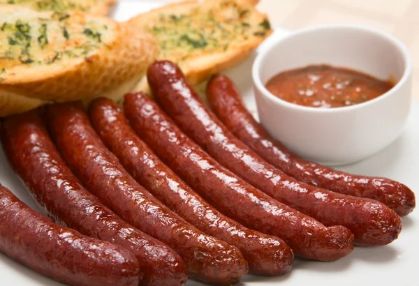 Grilled sausage with sauce on a plate — Stock Photo, Image