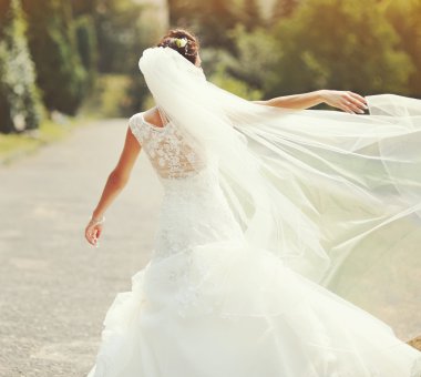 happy brunette bride spinning around with veil clipart