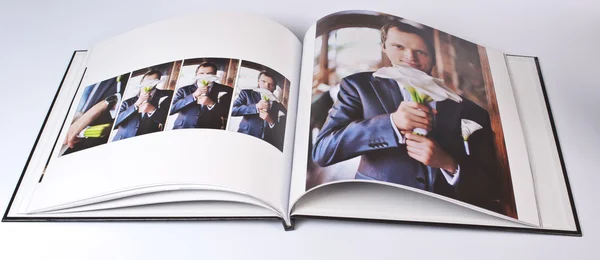 Wedding photo book of elegant young caucasian groom — Stock Photo, Image