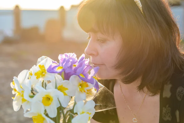 Middle-aged woman with flowers — Stock Photo, Image