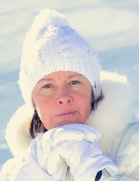 The woman of average years in a white knitted cap — Stock Photo, Image