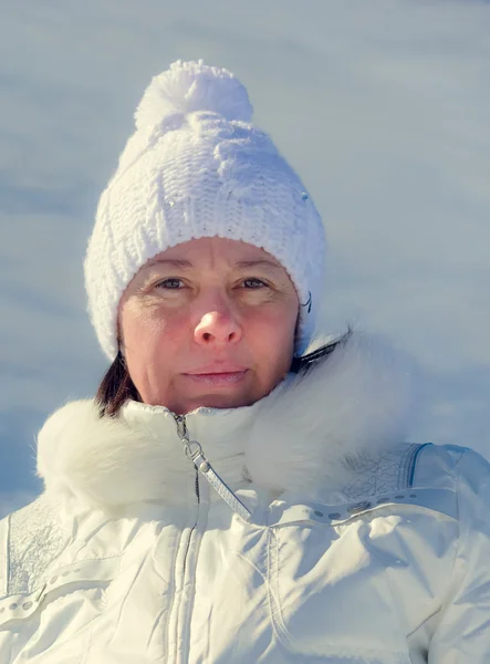 The woman of average years in a white knitted cap — Stock Photo, Image