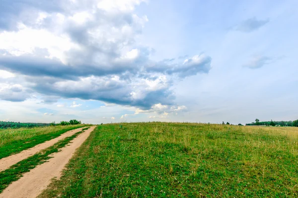 Dirt road in a field — Stock Photo, Image