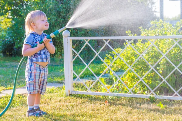 Boy with hose — Stock Photo, Image