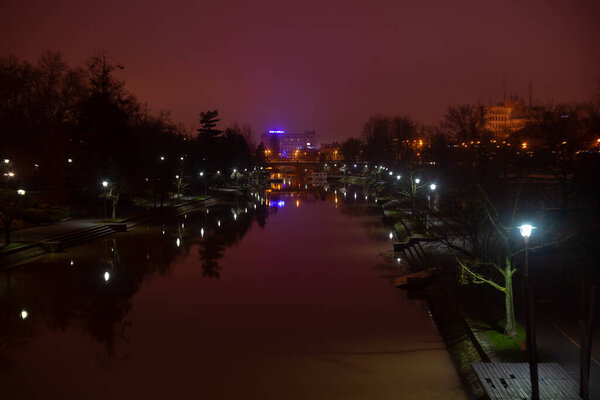 Timisoara, Romania - December 28, 2021: A view of the bega river. Night scene. The Politehnica University of Timisoara