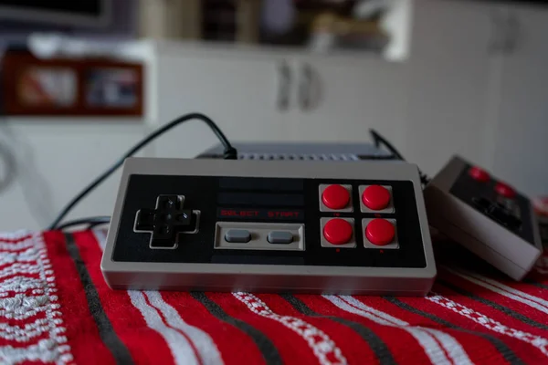 Retro gaming console with classic gamepad controller on a table