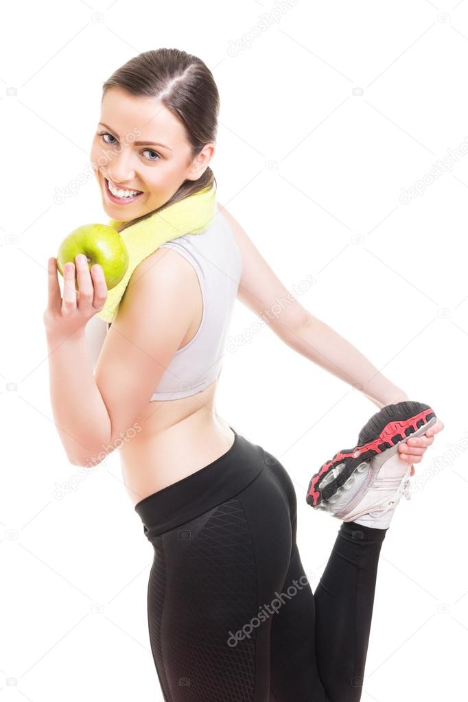 Fit young woman stretching out after workout