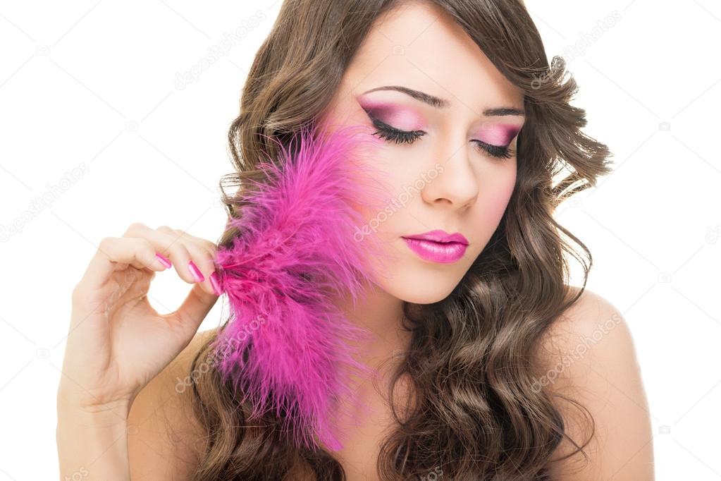 Glamorous young woman with pink feather
