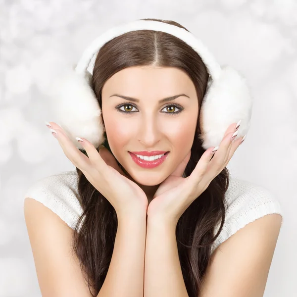 Cute young woman wearing ear muff smiling — Stock Photo, Image