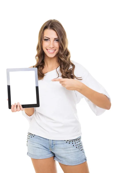 Attractive casual young woman showing tablet computer pointing at it — Stock Photo, Image