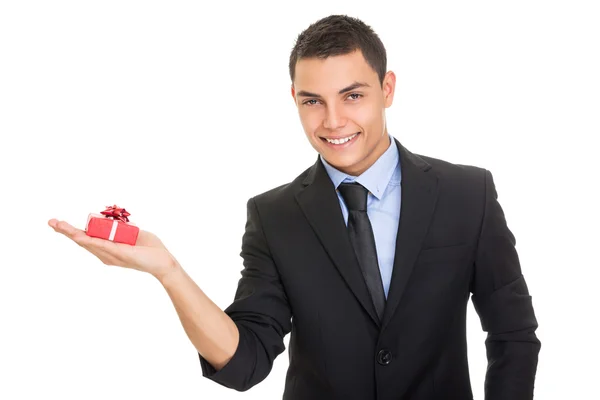 Elegant Hispanic businessman holding a gift box — Stock Photo, Image