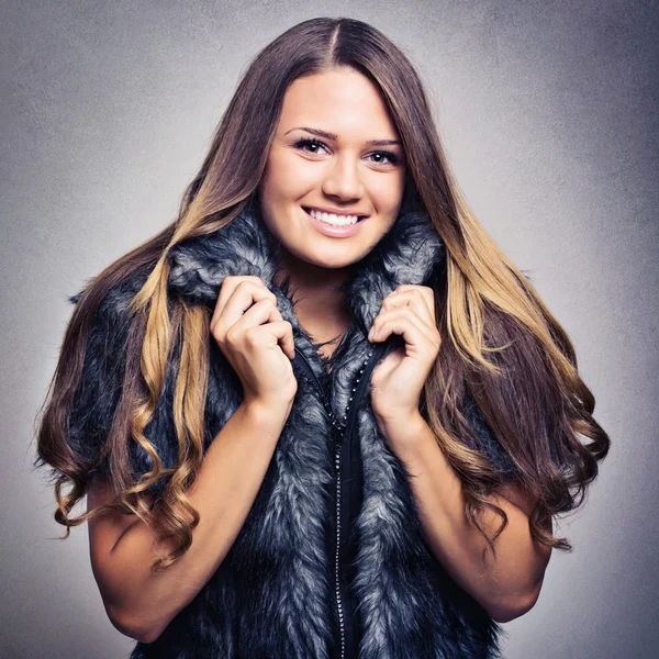 Attractive young woman wearing fur coat — Stock Photo, Image