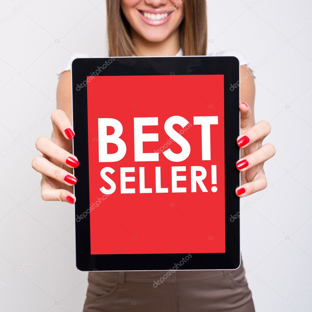 Woman showing tablet computer that states best seller