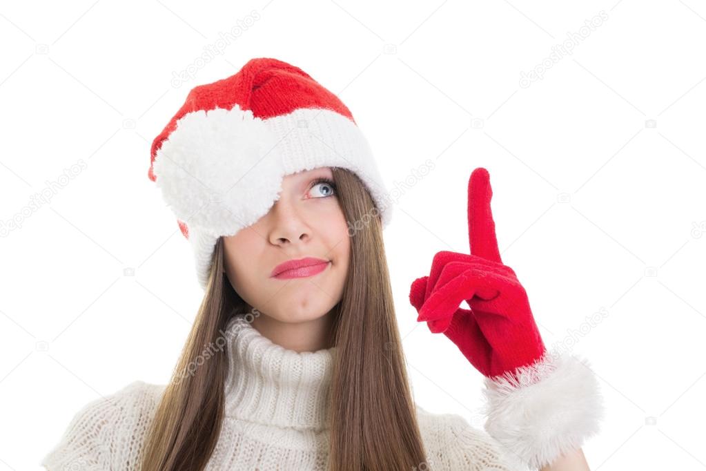 Not impressed girl with Santa beanie pointing and looking up