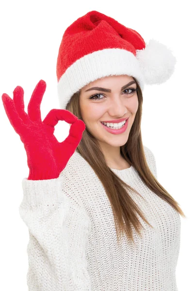 Χαριτωμένο νεαρή γυναίκα με καπέλο santa δείχνει εντάξει χειρονομία — Φωτογραφία Αρχείου