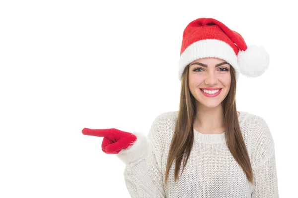 Glückliches Weihnachtsmädchen zeigt nach links — Stockfoto