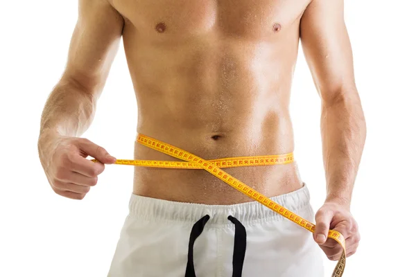 Fit body of shirtless man with tape measure — Stock Photo, Image