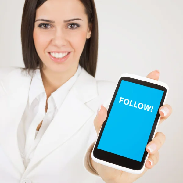 Businesswoman with smart phone that states follow — Stock Photo, Image