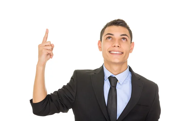 Feliz joven empresario hispano mirando y señalando hacia arriba Imagen De Stock